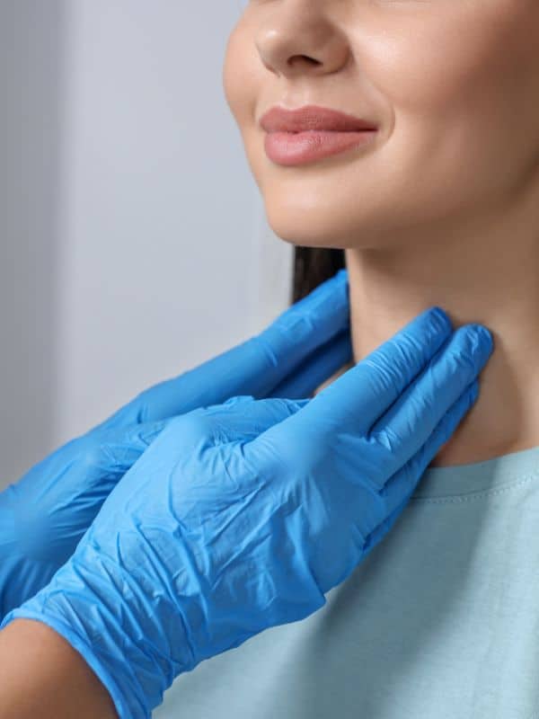 Endocrinology doctor hands on neck