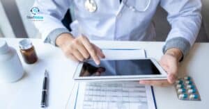 Doctor holding a clipboard while discussing credentials with admin staff