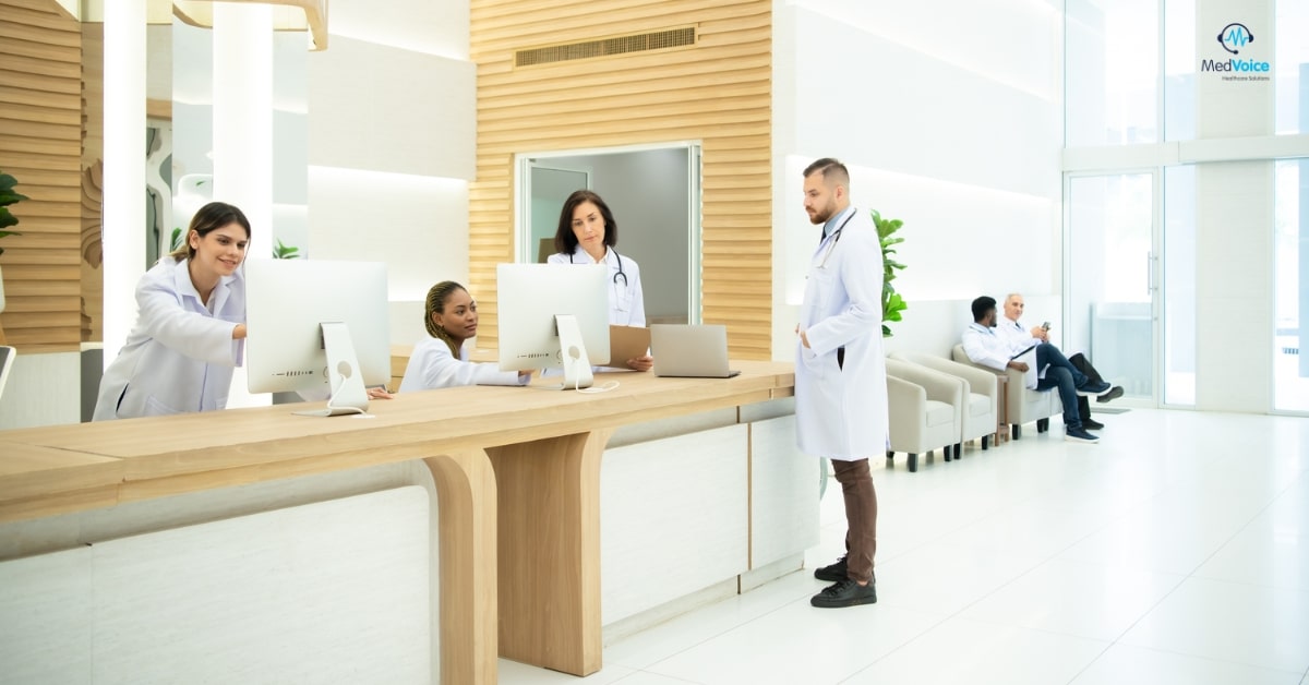 Small clinic medical staff reviewing billing and coding documents together.