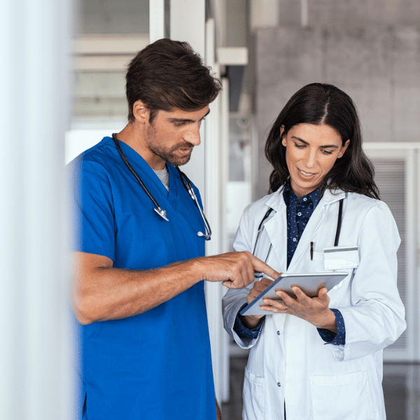 Physician overwhelmed by paperwork and administrative tasks in a small clinic.