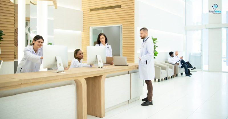 Small clinic medical staff reviewing billing and coding documents together.