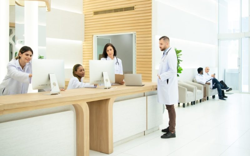 Small clinic medical staff reviewing billing and coding documents together.