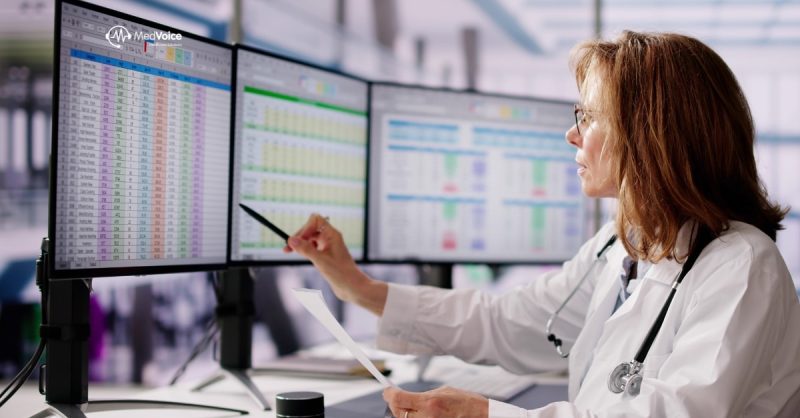 Medical coder reviewing healthcare records on computer for billing accuracy