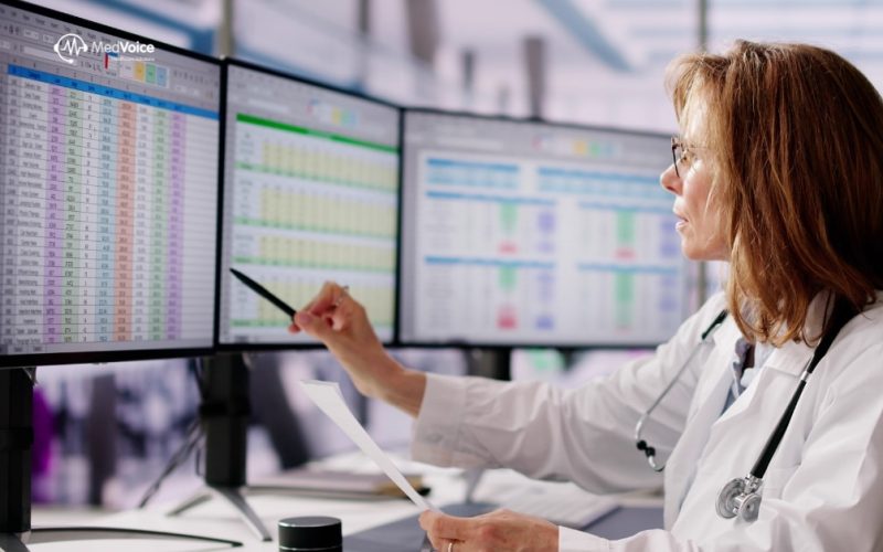 Medical coder reviewing healthcare records on computer for billing accuracy