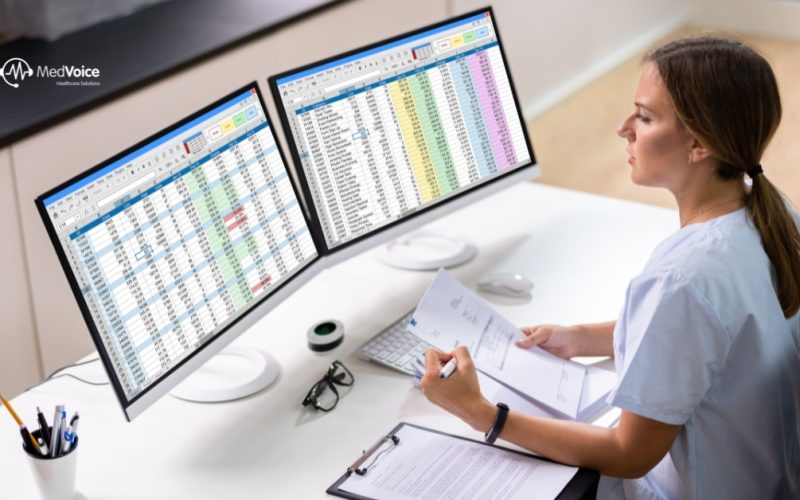 Healthcare team analyzing medical billing data in an office.