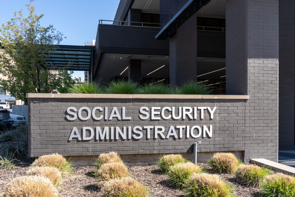 The exterior of a Social Security Administration building with its name displayed on a gray brick sign, perfect for a Medical Record Review landing page.