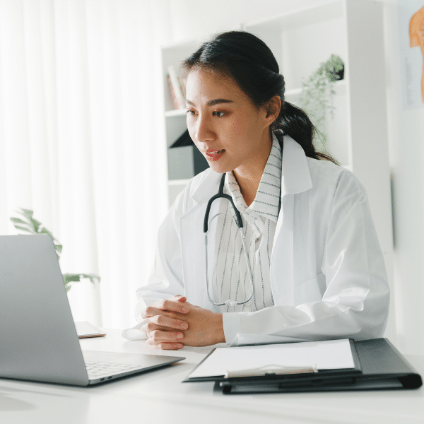 Medical coder entering diagnostic codes into electronic health records.