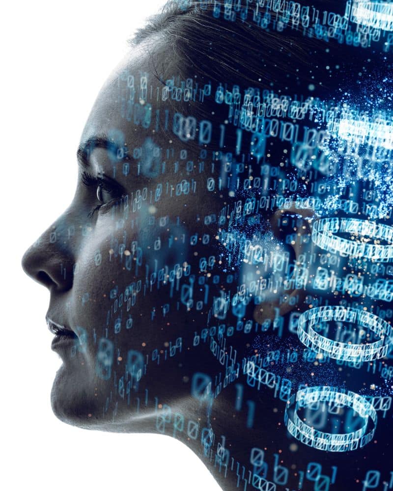 Profile of a woman's face blended with digital binary code, symbolizing the connection between technology, medical coding, and the human mind.