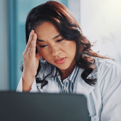 Close up of medical billing forms and coding documents on a desk.