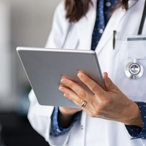 A person wearing a white lab coat and stethoscope uses a tablet device, illustrating how independent practices can leverage outsourcing medical billing for greater efficiency.